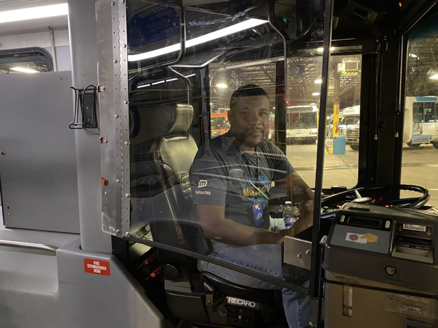 Metro bus driver sits behind protective COVID-19 safety shield