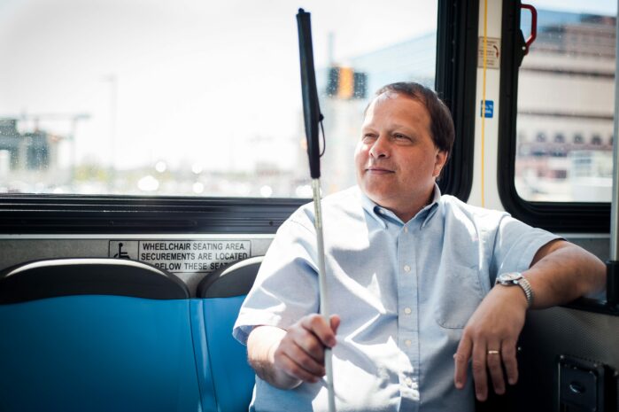 Blind passenger with cane riding the bus