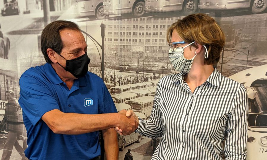 Metro’s former Executive Director, Curt Simon, shakes hands with incoming CEO, Lauren Cencic.