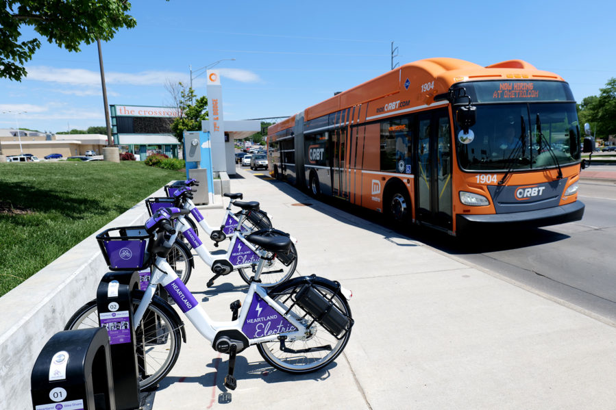 A photo of a new Heartland Bike Share station at the 72nd westbound ORBT Station with an ORBT bus driving past